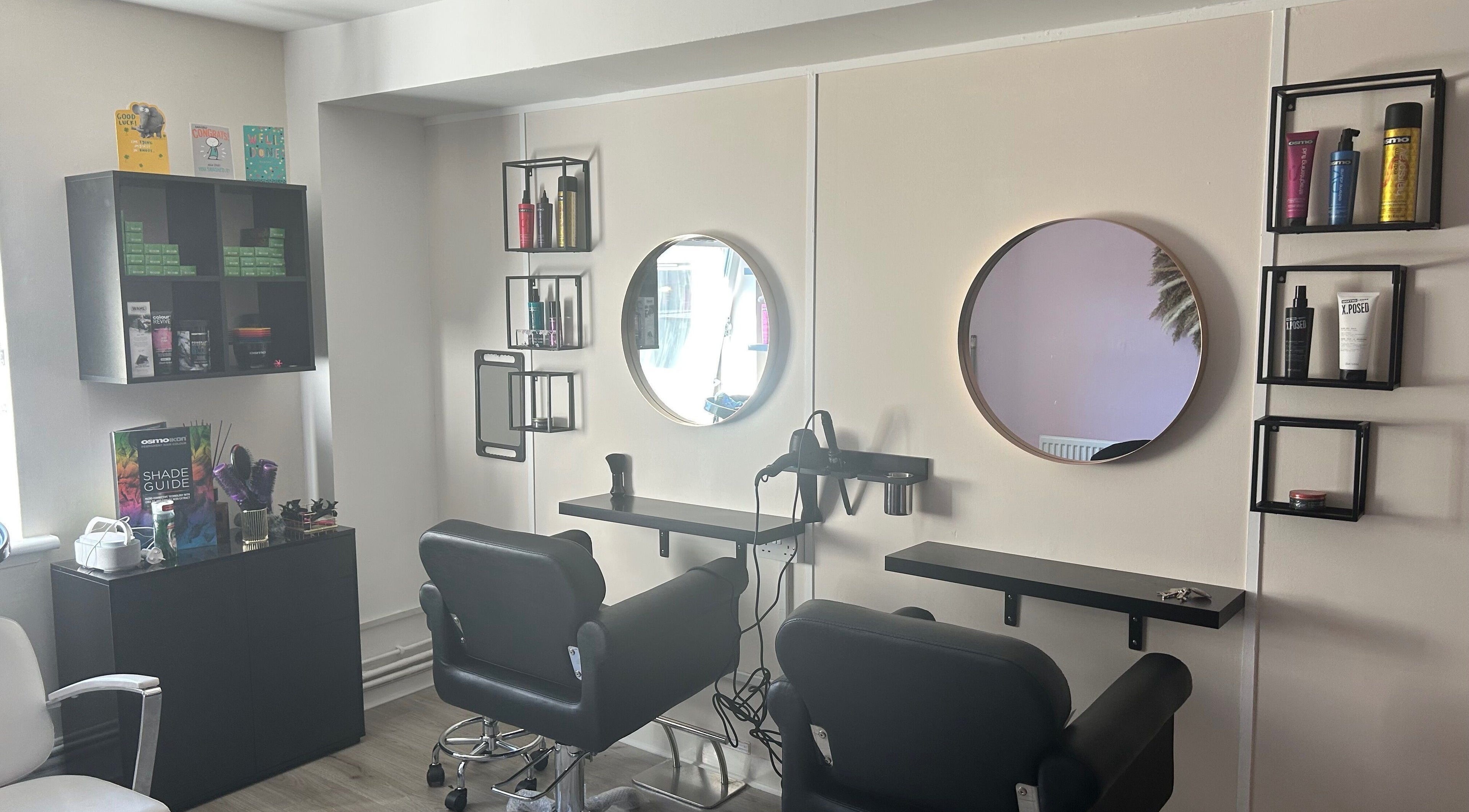 Cozy salon interior at Locks of Love Hair by Claire, Paisley, Scotland, GB, showcasing chic styling chairs and mirrors.