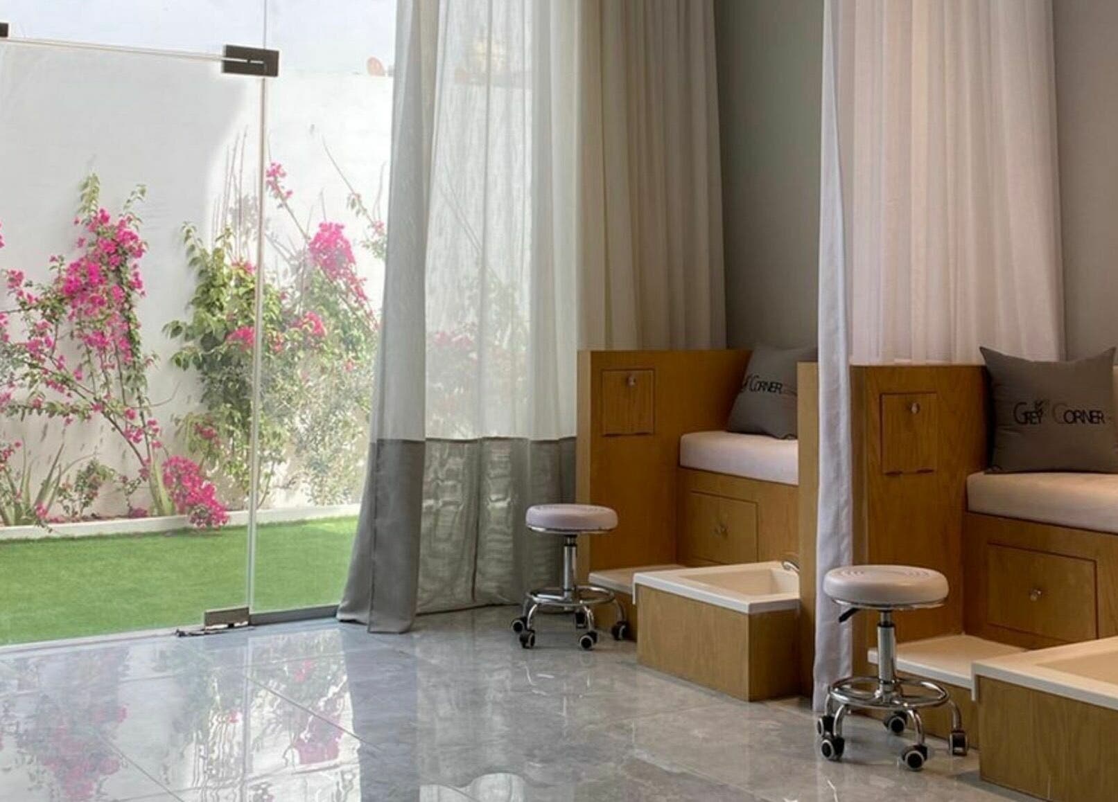 Tranquil pedicure area at Grey Corner Salon, Al Mubarraz, Eastern Province, SA with greenery view outside.