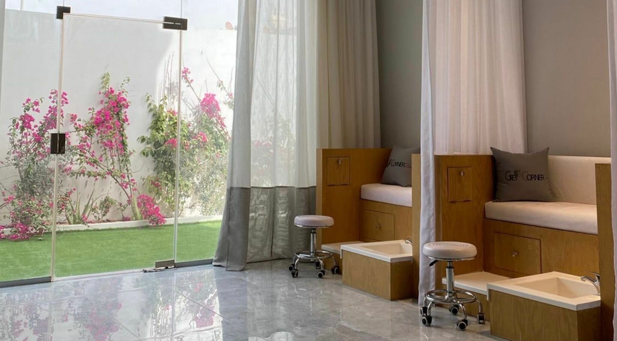 Tranquil pedicure area at Grey Corner Salon, Al Mubarraz, Eastern Province, SA with greenery view outside.