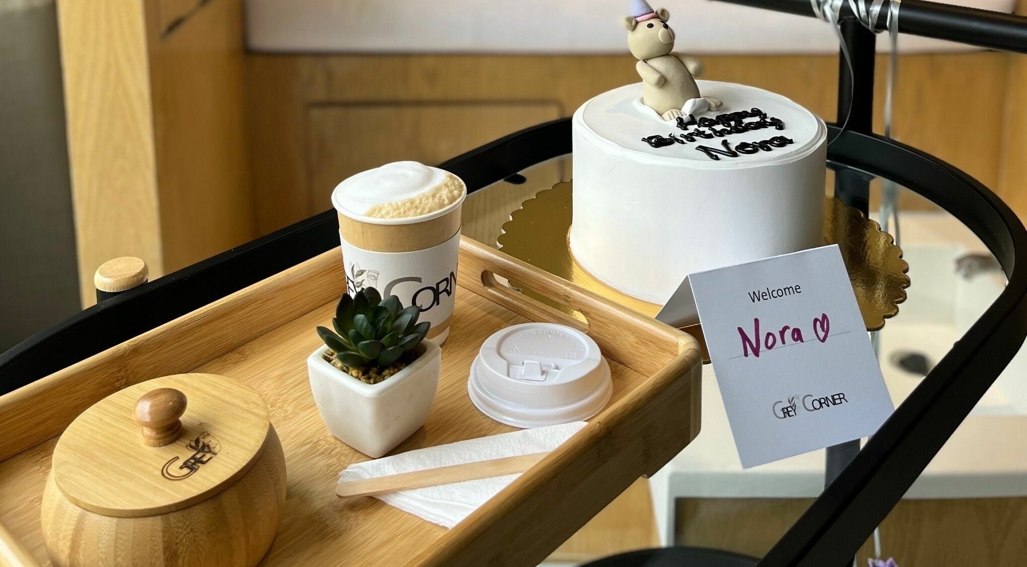 Welcome display with cake and coffee at Grey Corner Salon, Al Mubarraz, Eastern Province, SA.