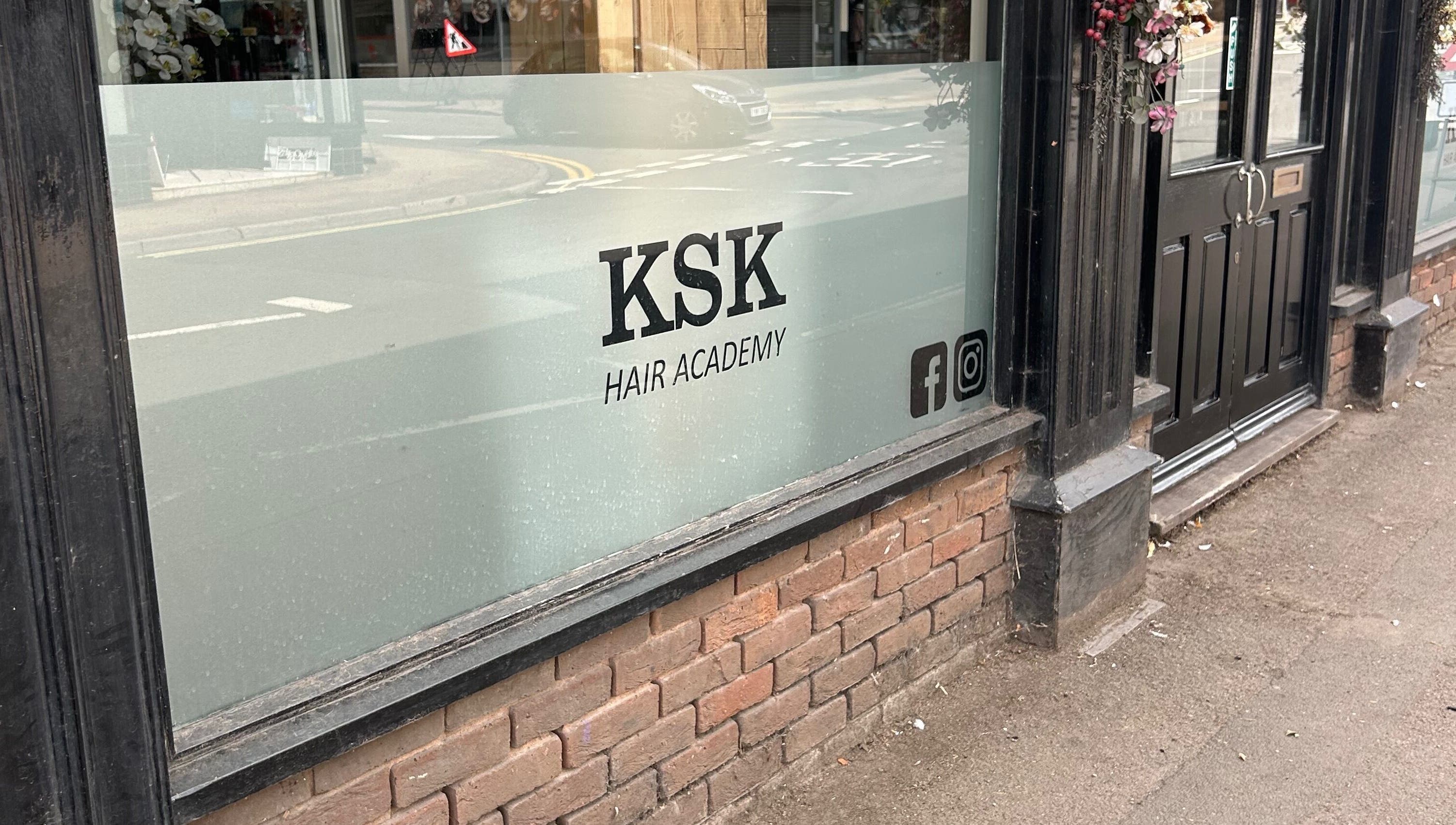 Exterior view of Ksk Hair Academy, Lydney, England, showing the entrance and signage on the window.