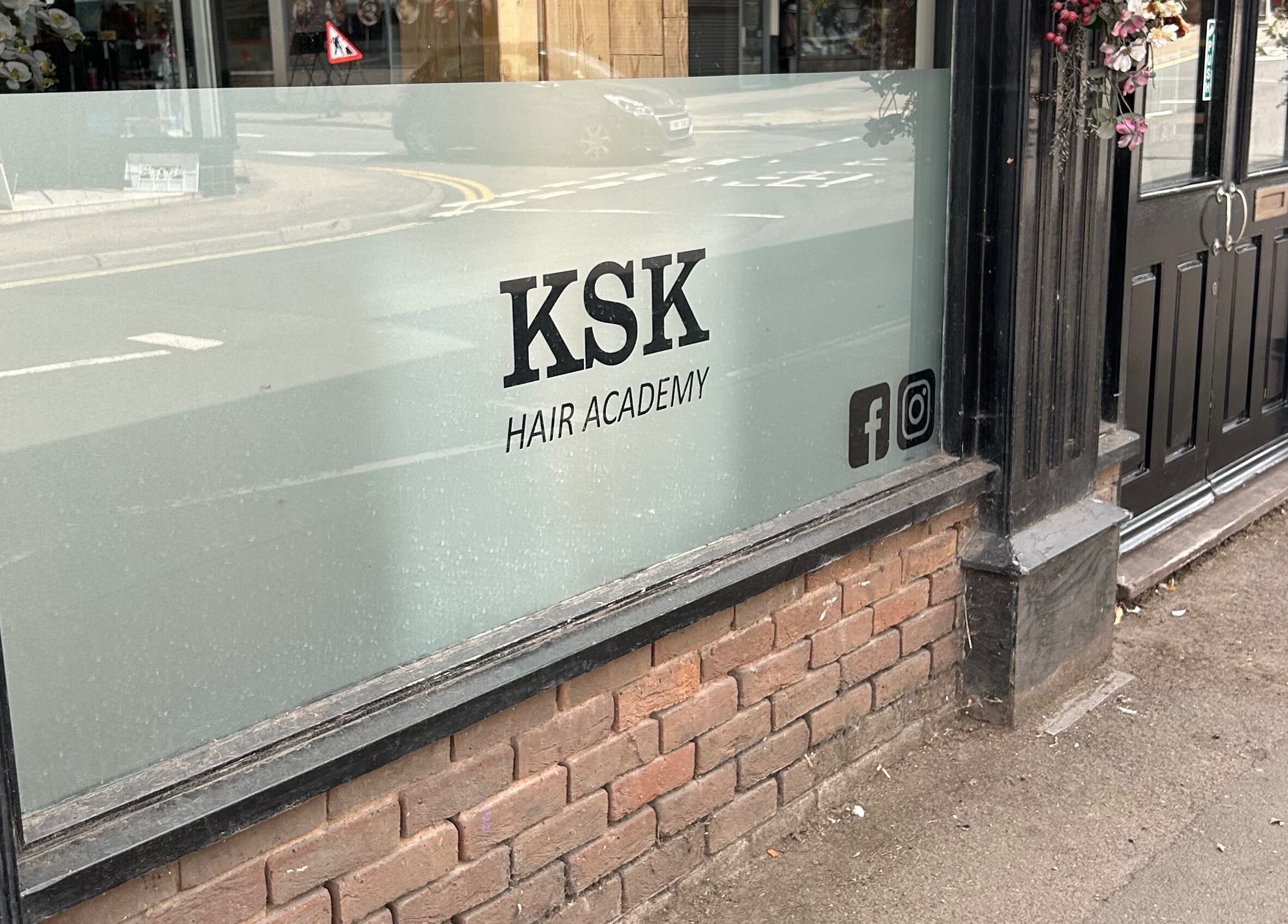Exterior view of Ksk Hair Academy, Lydney, England, showing the entrance and signage on the window.