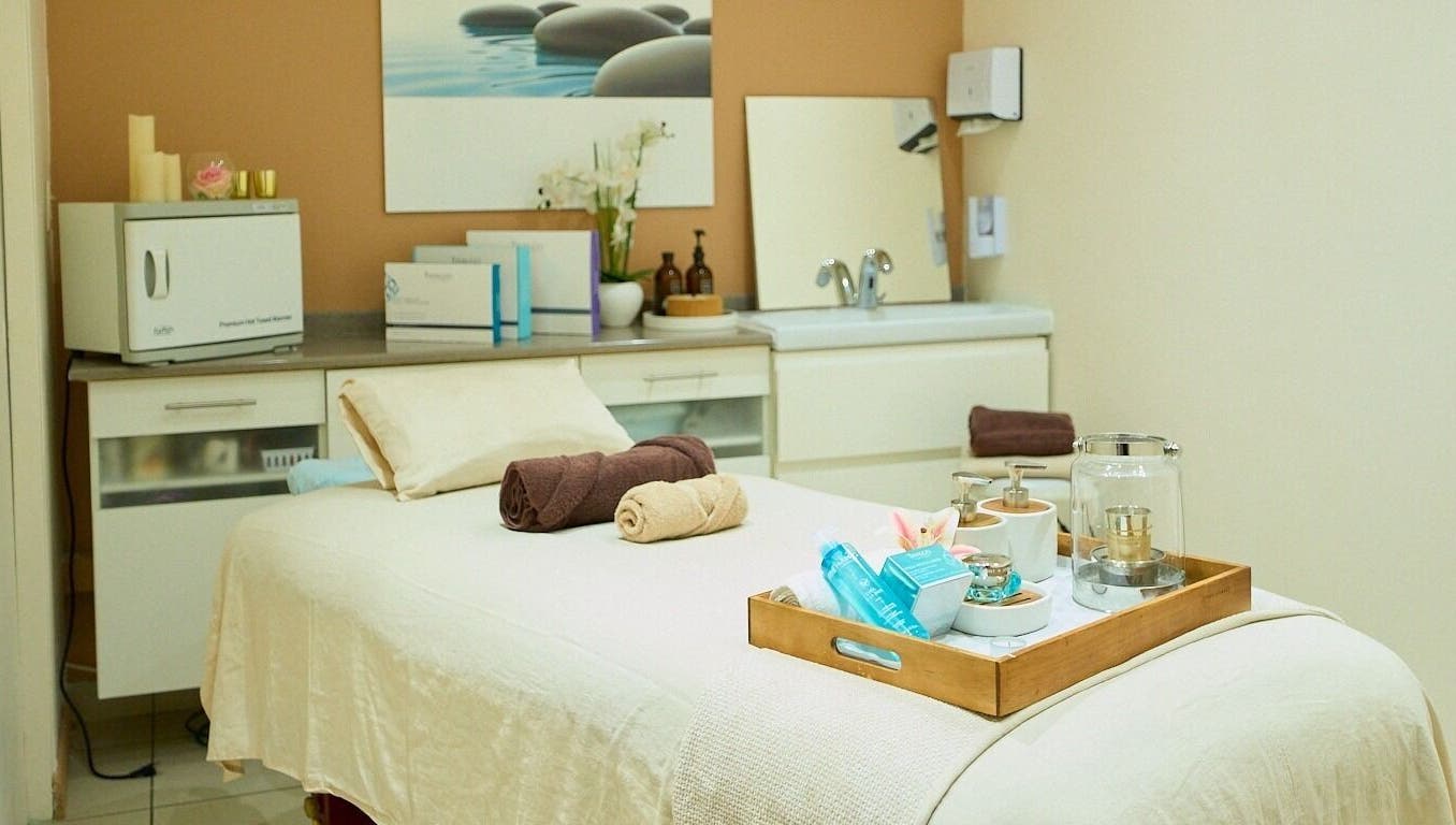 Serene spa room at Vita Flora, Simpson Bay, Sint Maarten, SX, showcasing a massage table with towels and products.