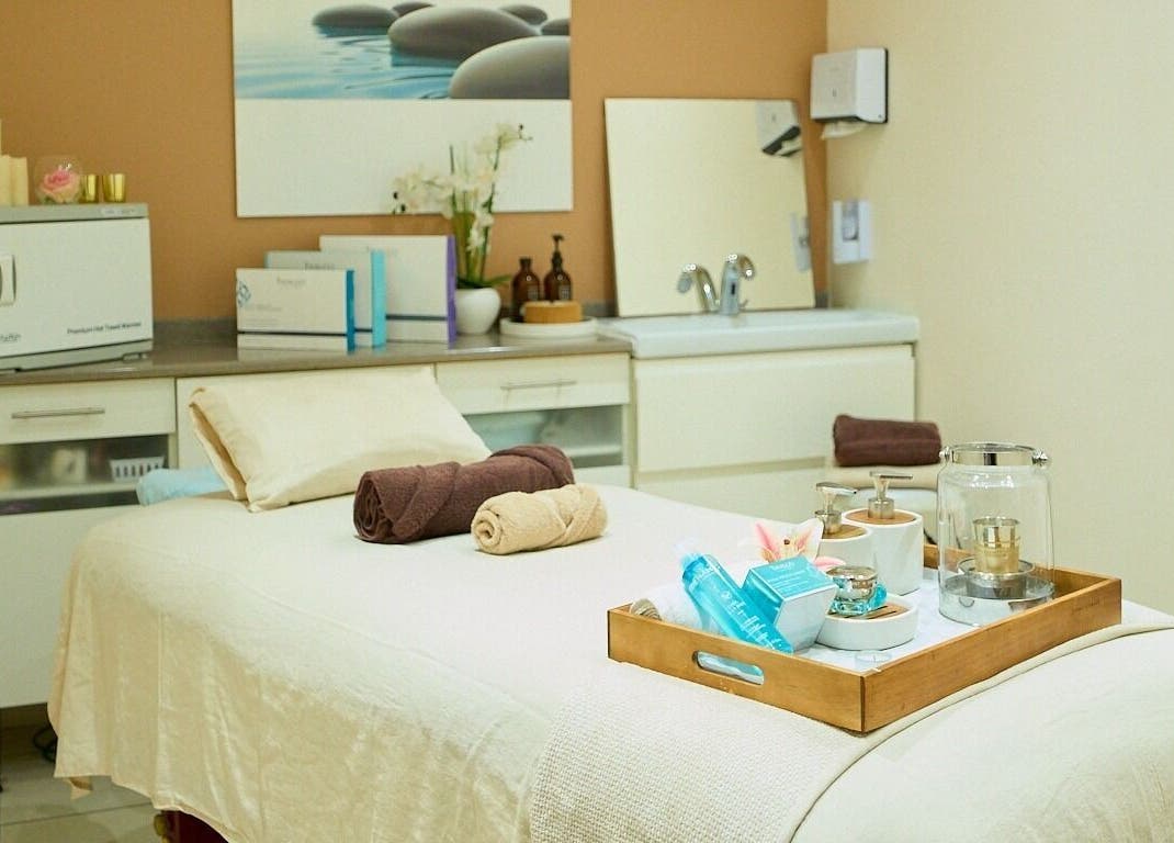 Serene spa room at Vita Flora, Simpson Bay, Sint Maarten, SX, showcasing a massage table with towels and products.