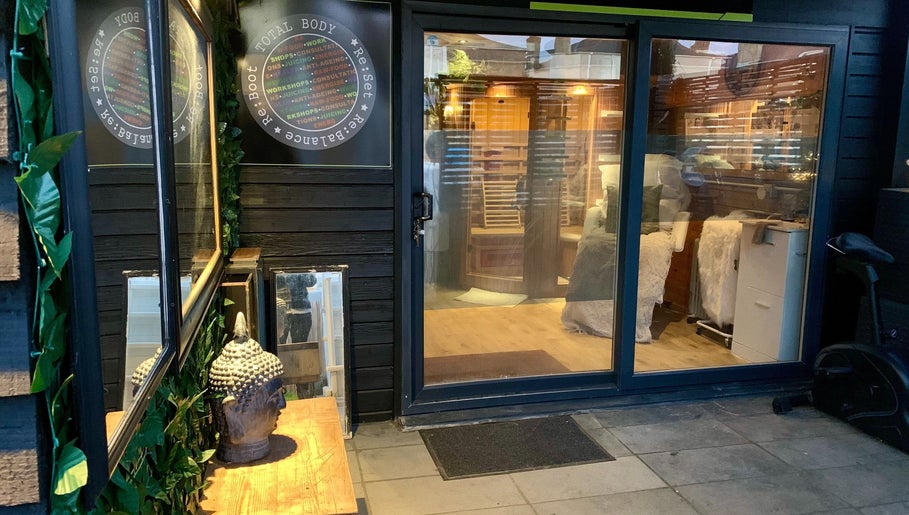 Entrance of Pure Calma Healing spa in Bournemouth, England, showcasing serene ambiance and inviting décor.