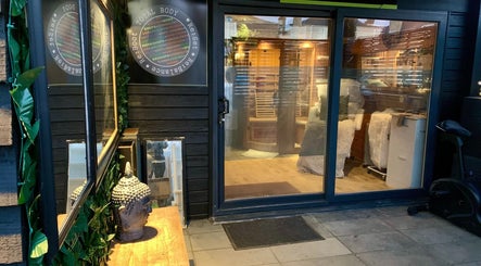 Entrance of Pure Calma Healing spa in Bournemouth, England, showcasing serene ambiance and inviting décor.