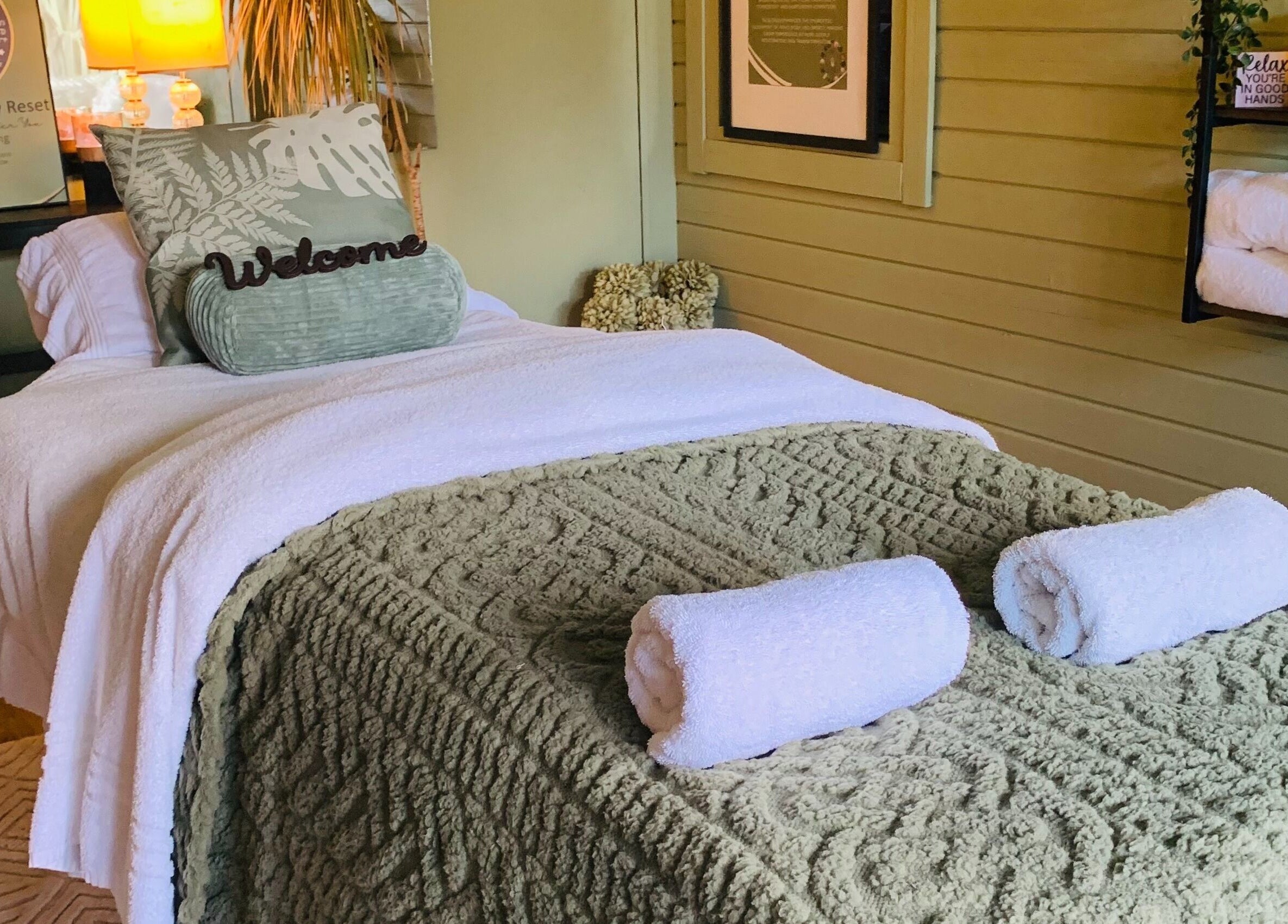 Relaxing treatment room at Pure Calma Healing, Bournemouth, England, GB with cozy bed and soothing decor.