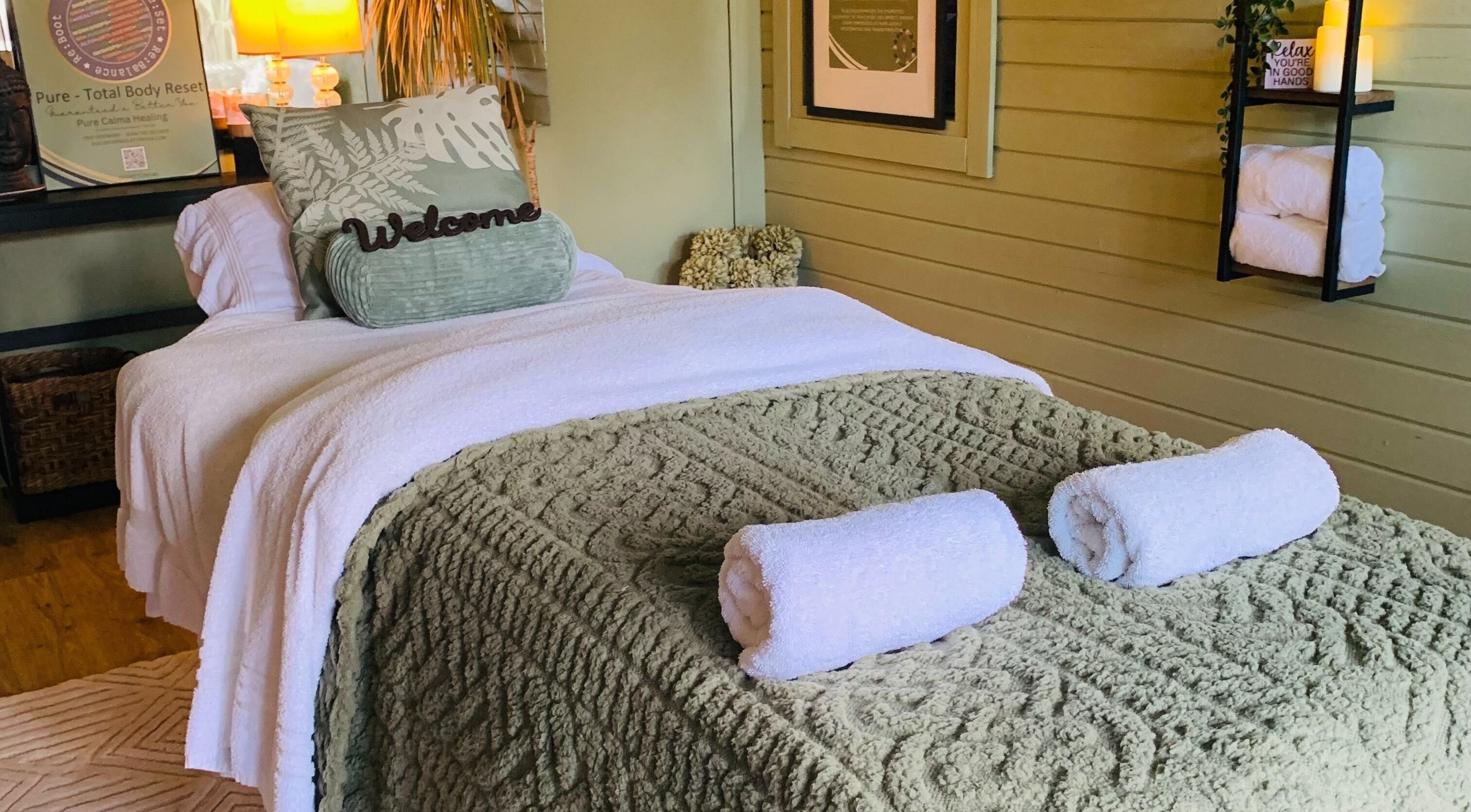 Relaxing treatment room at Pure Calma Healing, Bournemouth, England, GB with cozy bed and soothing decor.