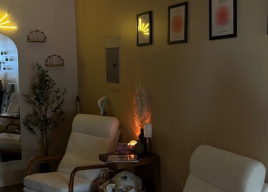 Relaxing seating area at DX Beauty Lounge in Joliet, Illinois, featuring elegant decor and ambient lighting.