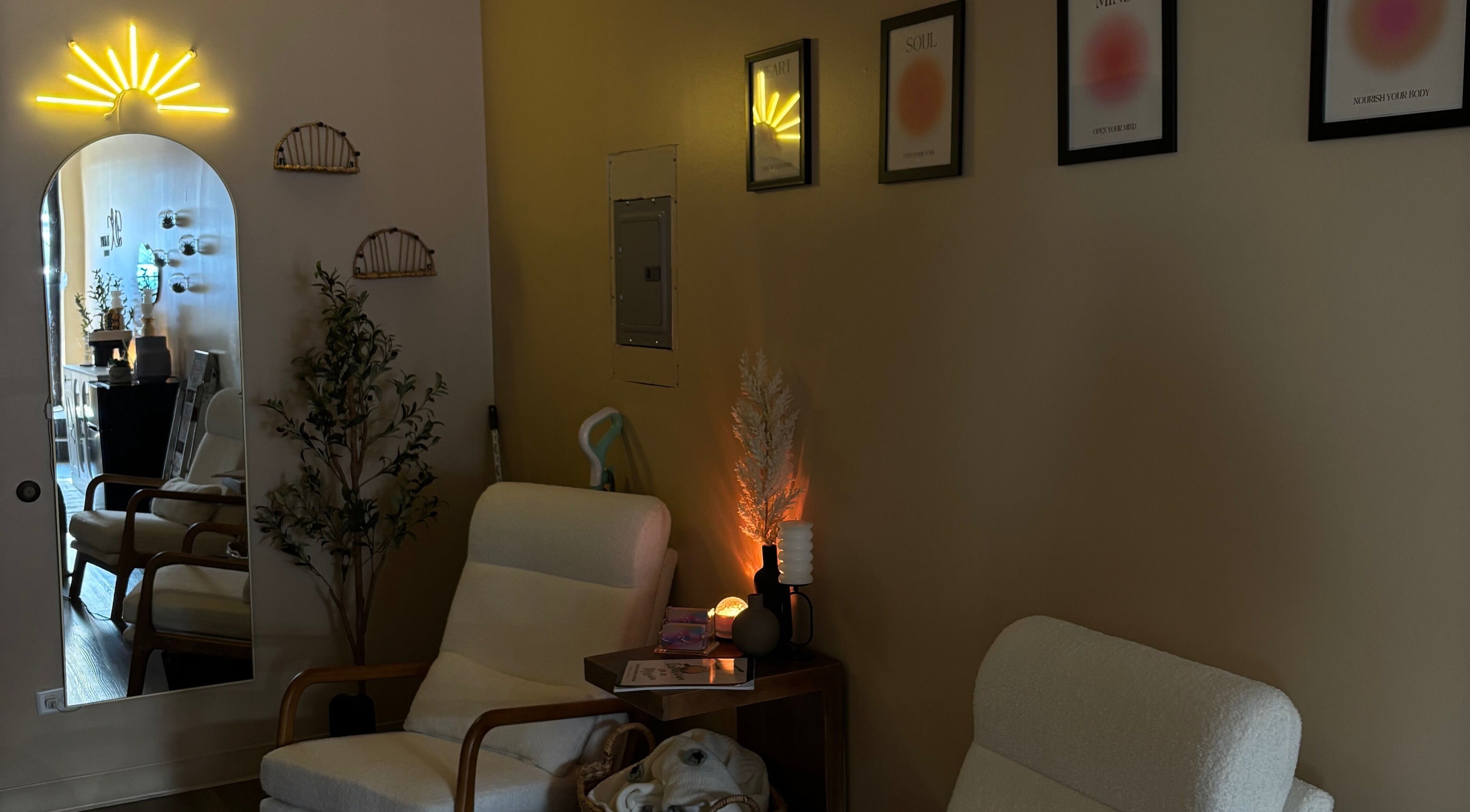 Relaxing seating area at DX Beauty Lounge in Joliet, Illinois, featuring elegant decor and ambient lighting.