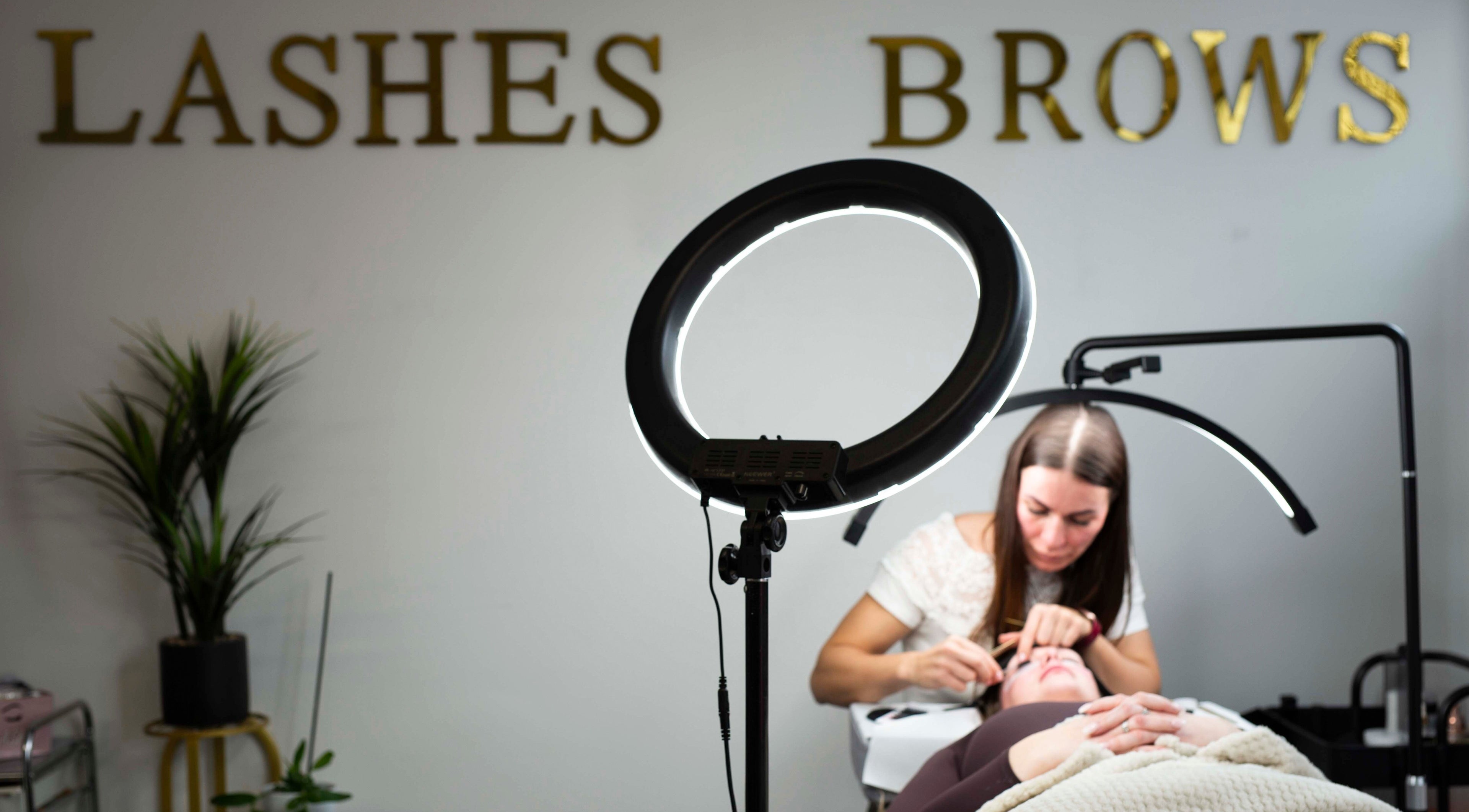 Lash artist at Belle Beauty Studio & Academy, Gravesend, England, GB, applying extensions under professional lighting.