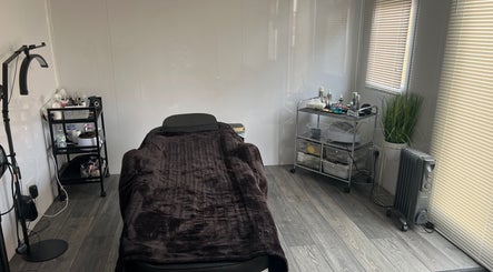 Relaxing treatment room at Beauty by JM, Telford, England, GB, featuring a cozy bed and elegant decor.