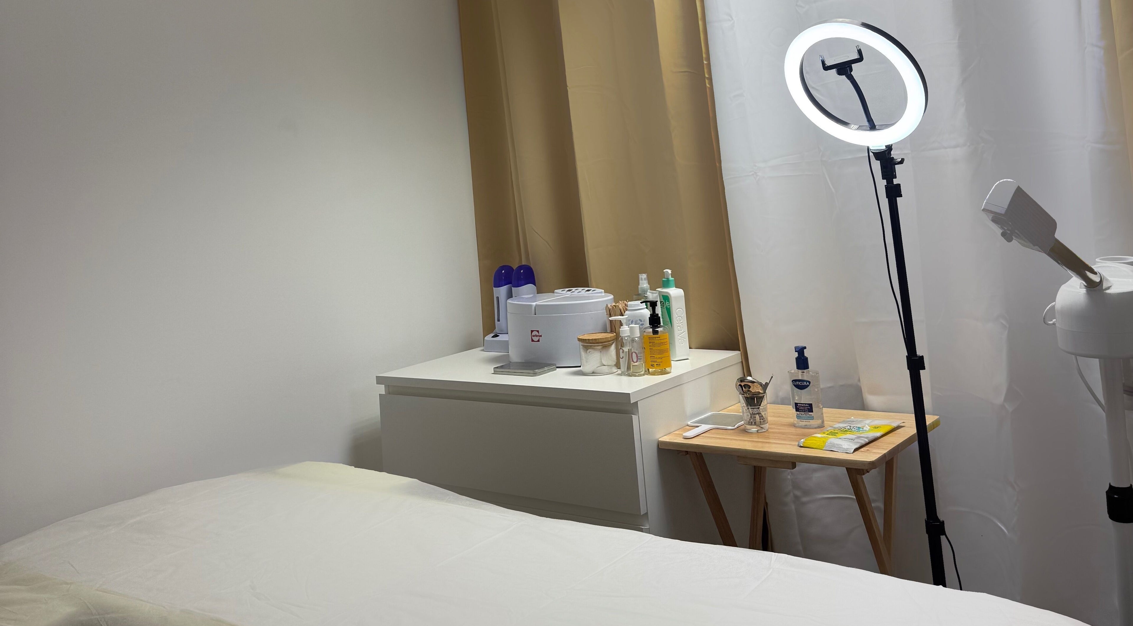 Tranquil treatment room at Heaveneabeautyuk, Woodford Green, England, GB, featuring spa essentials and lighting.