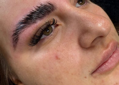 Close-up of a woman's enhanced eyebrows and eyelashes at Bonito Hair and Beauty, Rushden, England, GB.