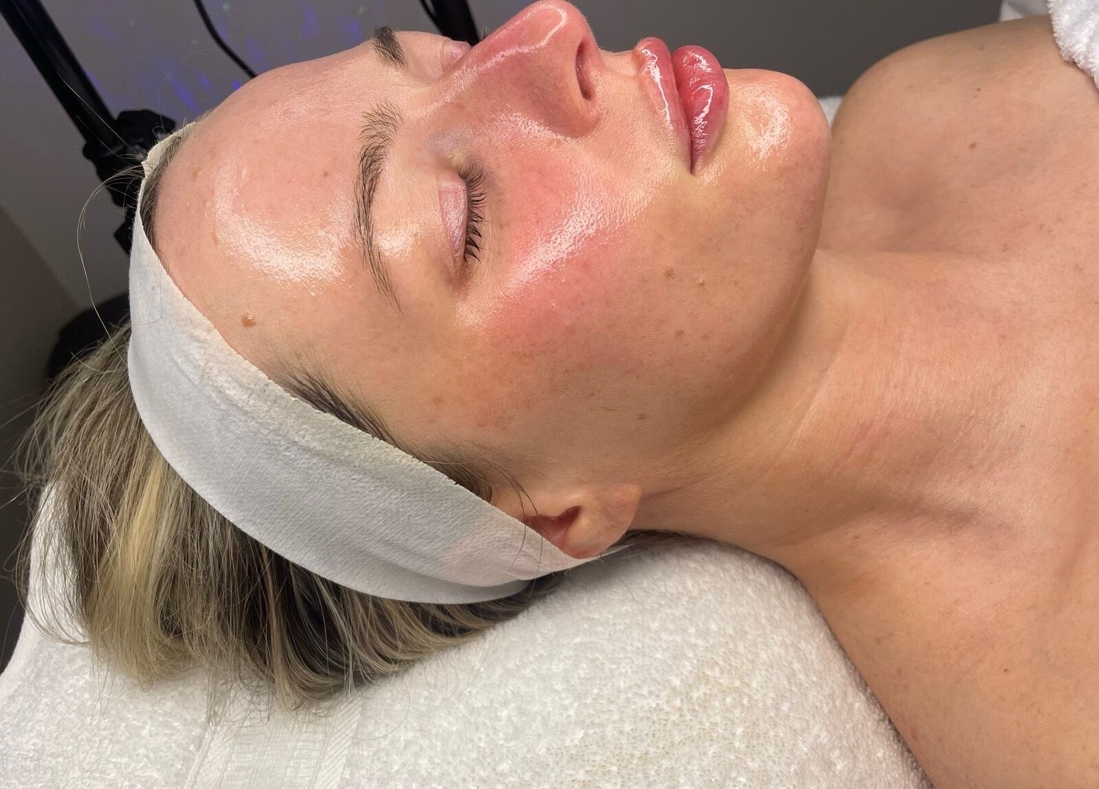 Relaxed woman receiving facial treatment at Skin Deep in Worsley, England, GB showcasing glowing skin beauty.