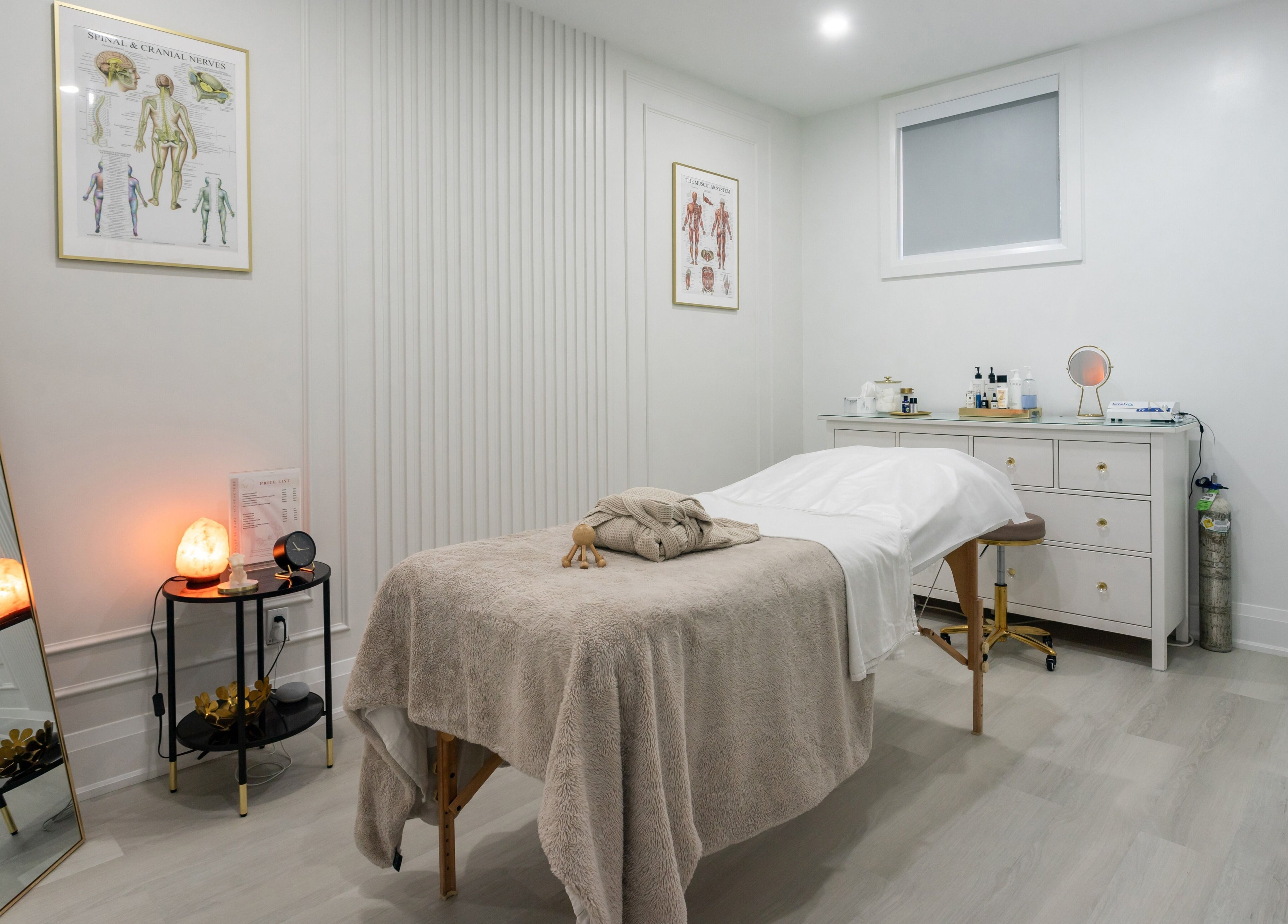 Serene spa treatment room at Aura Wellness in Vaughan, Ontario, CA with massage table and calming decor.