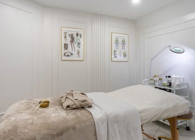 Relaxing treatment room at Aura Wellness in Vaughan, Ontario, CA, featuring a massage bed and calming decor.