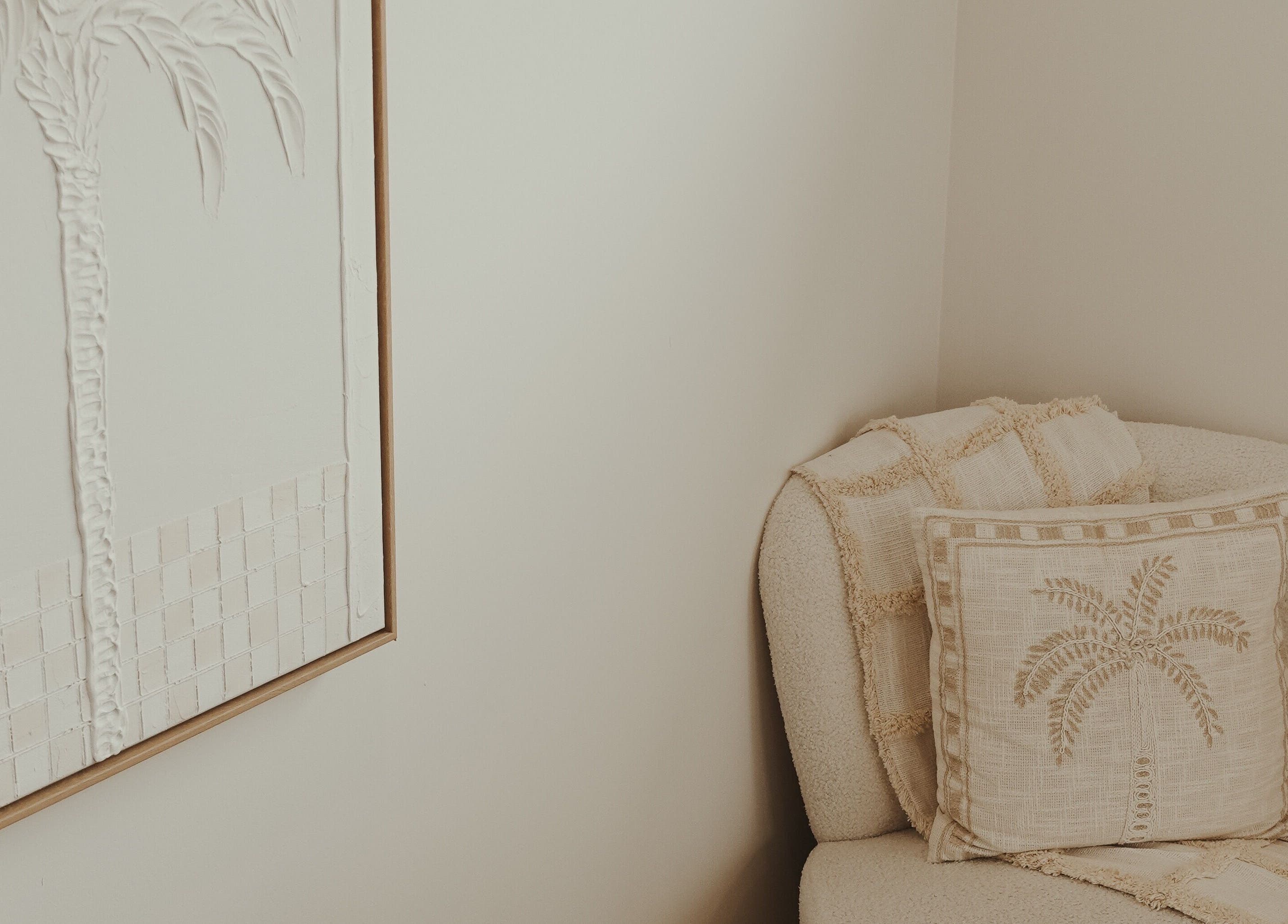 Cozy corner with palm décor at ILash and Beauty Bar, Baringa, Queensland, AU, offering relaxation and elegance.