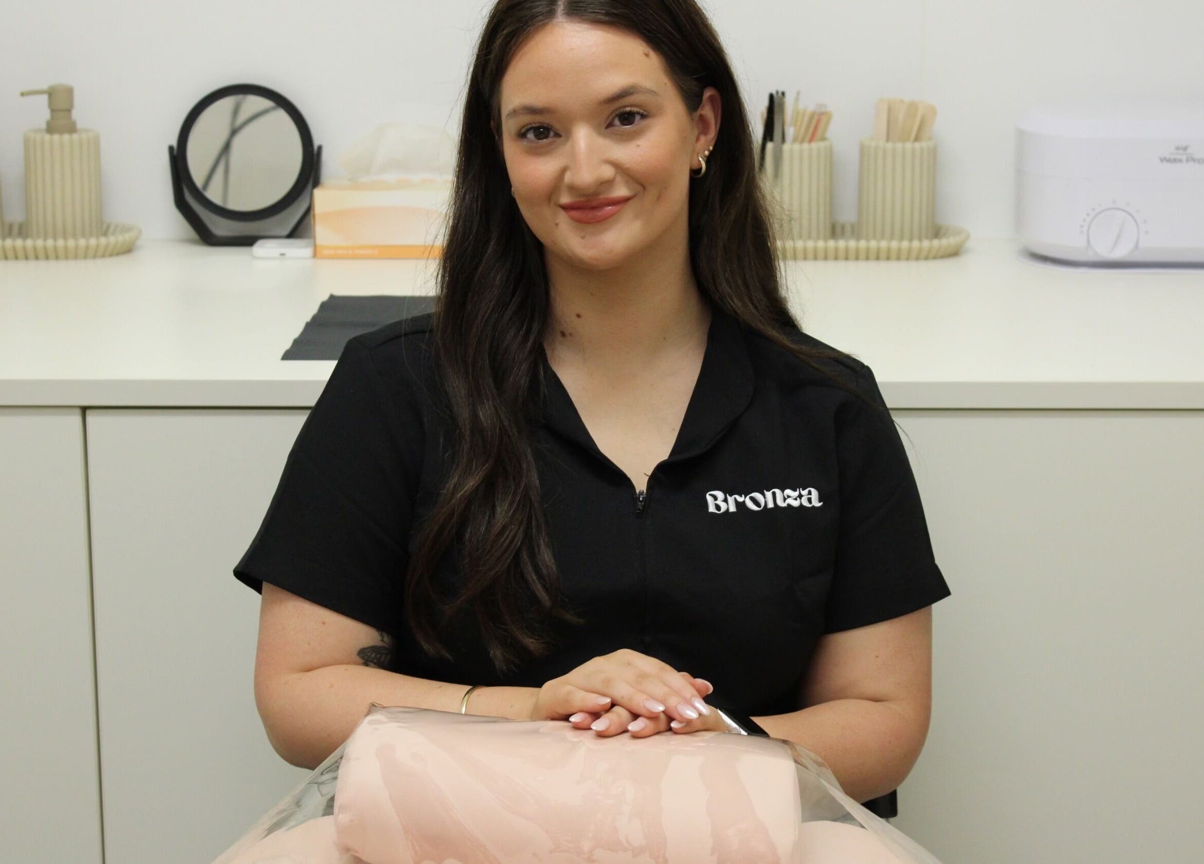 Bronza staff member in a chic interior, Warrnambool, Victoria, AU, embodying relaxation and professionalism.