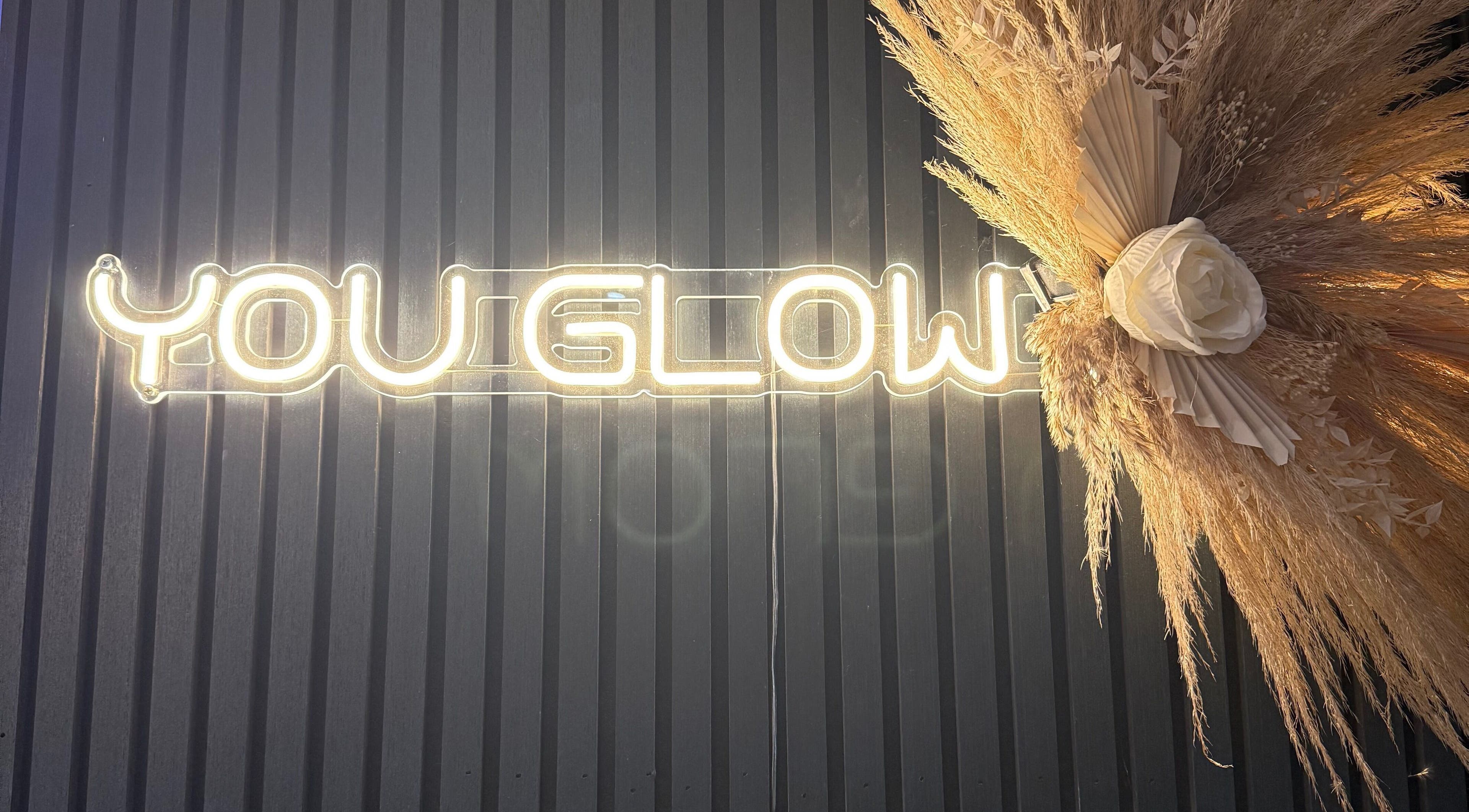 Neon 'You Glow' sign with floral decor at The Glam Bar in Auchterarder, Scotland, GB.