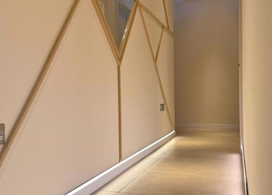 Modern geometric design hall at SKiN At The Collective, Gibraltar, GI, with ambient lighting.