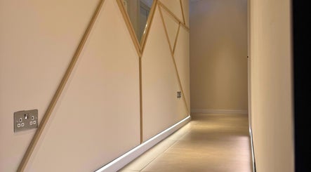 Modern geometric design hall at SKiN At The Collective, Gibraltar, GI, with ambient lighting.