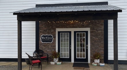Welcoming entrance of ReVive at the Ridge - Fuquay in Fuquay-Varina, North Carolina, US with seating area.
