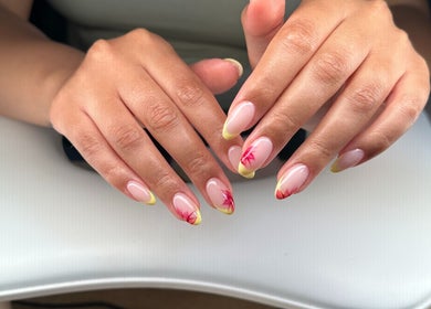 Stylish floral nail art at Polished By Sam in Bracknell, England, GB. Detailed design with yellow and red accents.