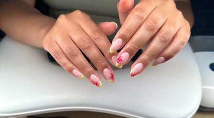 Stylish floral nail art at Polished By Sam in Bracknell, England, GB. Detailed design with yellow and red accents.