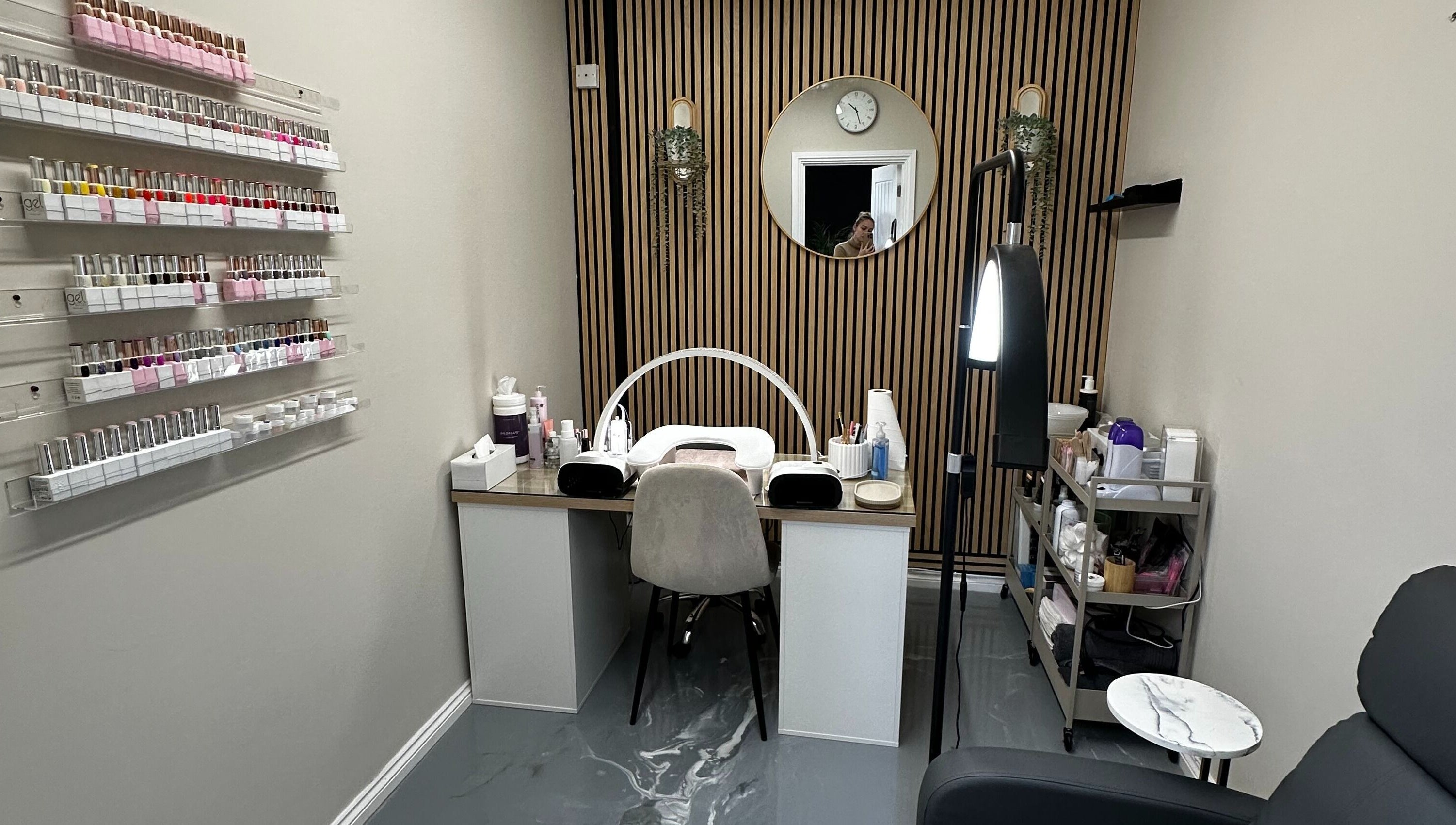 Modern nail service area at Polished By Sam, Bracknell, England, GB with elegant decor and polishes displayed.