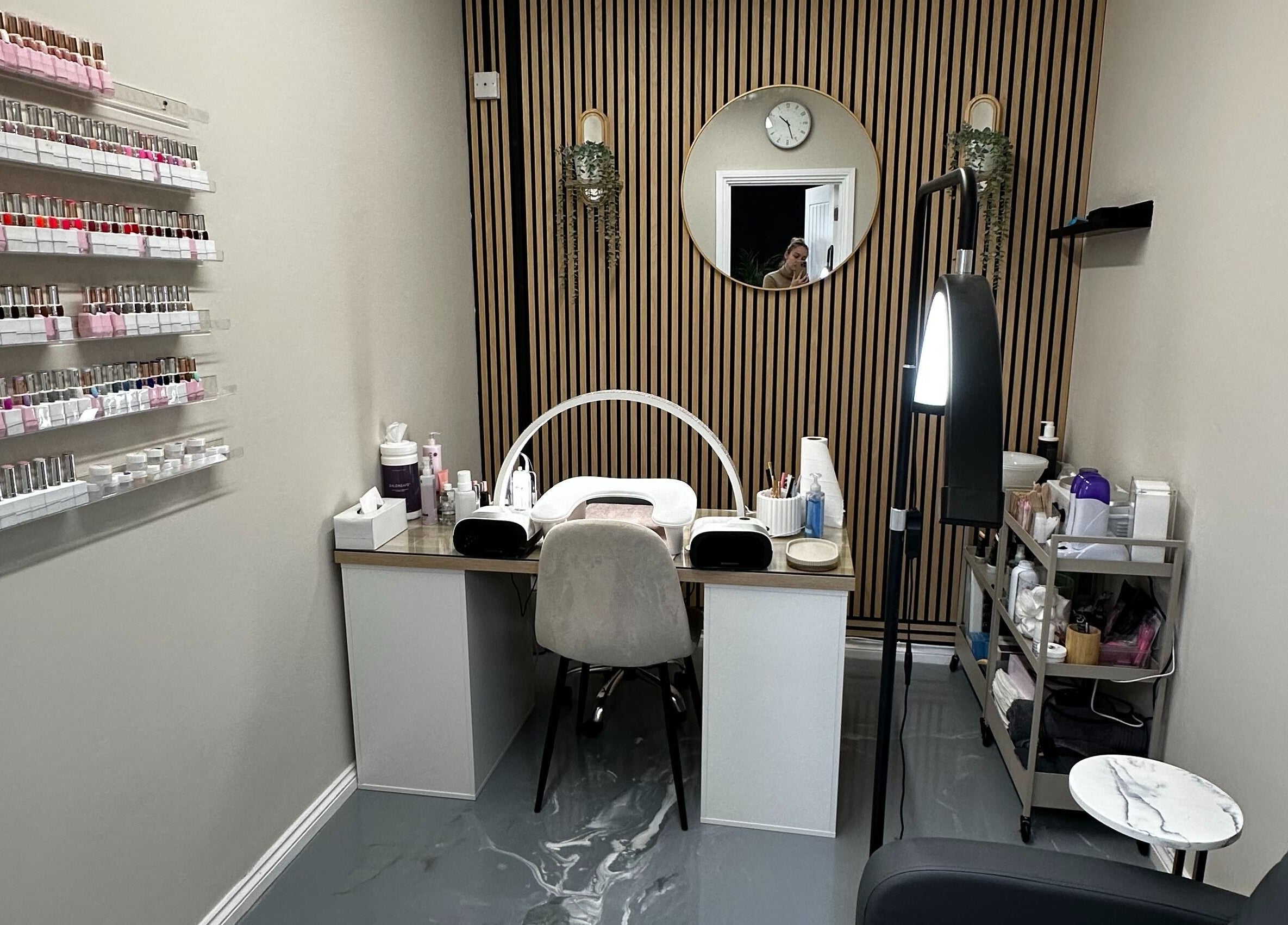 Modern nail service area at Polished By Sam, Bracknell, England, GB with elegant decor and polishes displayed.
