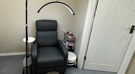 Comfortable seating area at Polished By Sam, Bracknell, England, GB, featuring a sleek black chair and modern lighting.