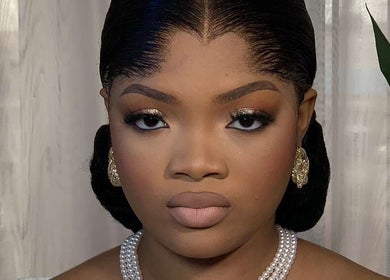 Sophisticated makeup look at Belleyenn Artistry, Lagos, Lagos, NG with gold eyeshadow and pearl earrings.