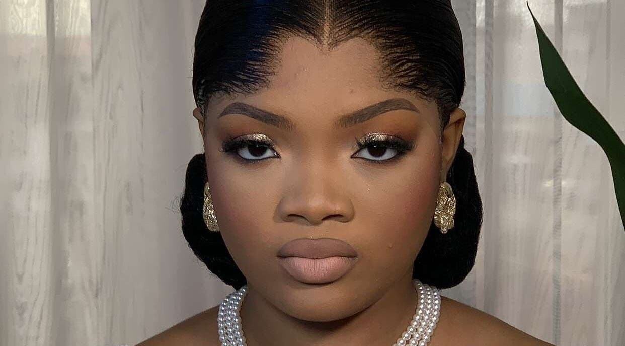 Sophisticated makeup look at Belleyenn Artistry, Lagos, Lagos, NG with gold eyeshadow and pearl earrings.