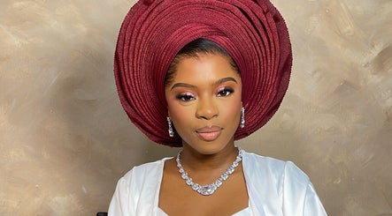 Woman wearing a red traditional headpiece and jewelry at Belleyenn Artistry, Lagos, Lagos, NG.