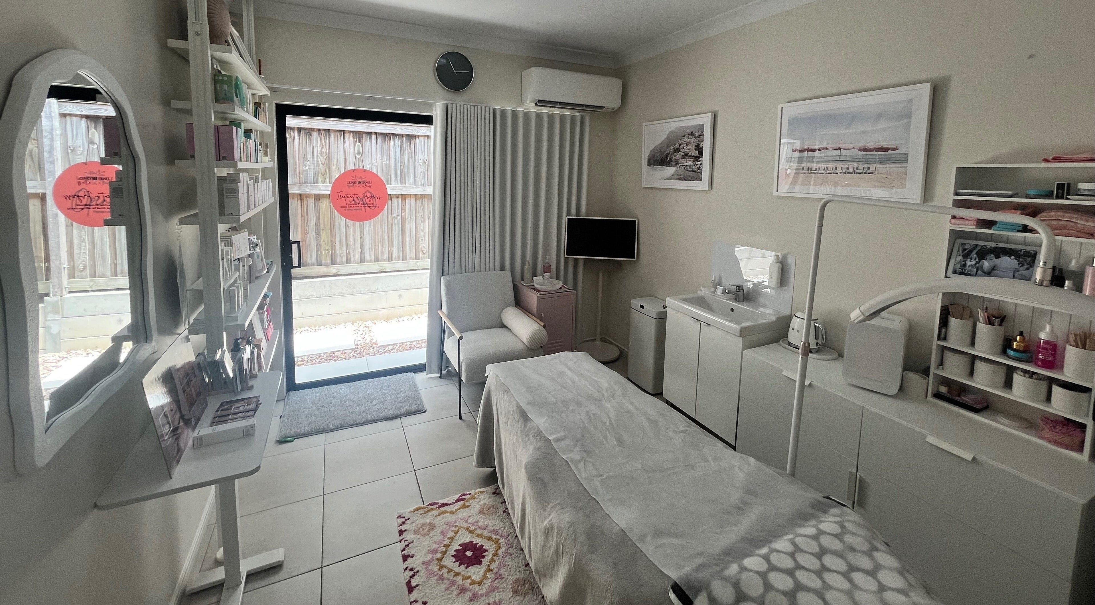 Cozy treatment room at Luxe Brows & Beauty in Brookwater, Queensland, AU with comfortable chair and beauty equipment.