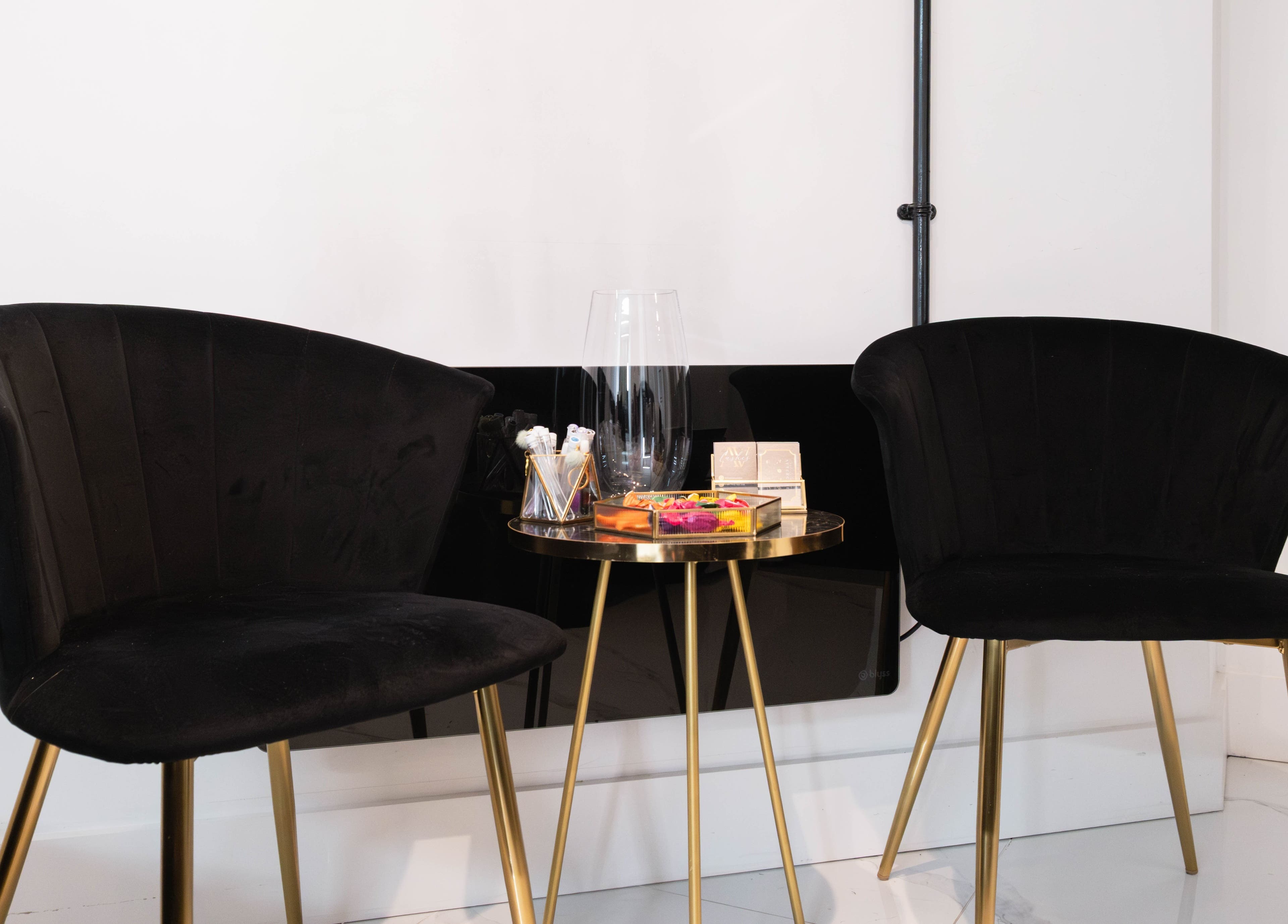 Modern black chairs and table at AV Lashes London, London, England, GB, showcasing elegance and style.