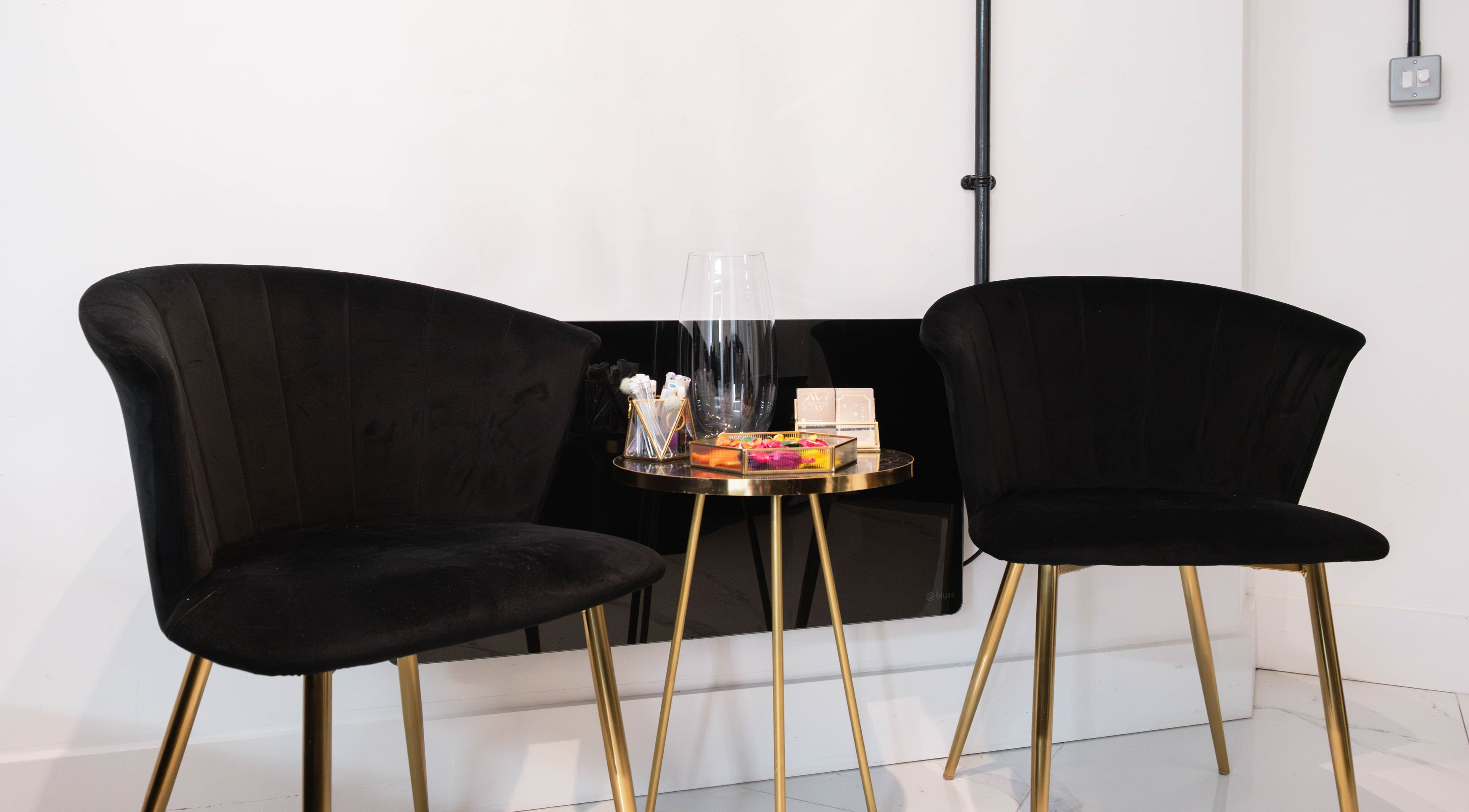 Modern black chairs and table at AV Lashes London, London, England, GB, showcasing elegance and style.