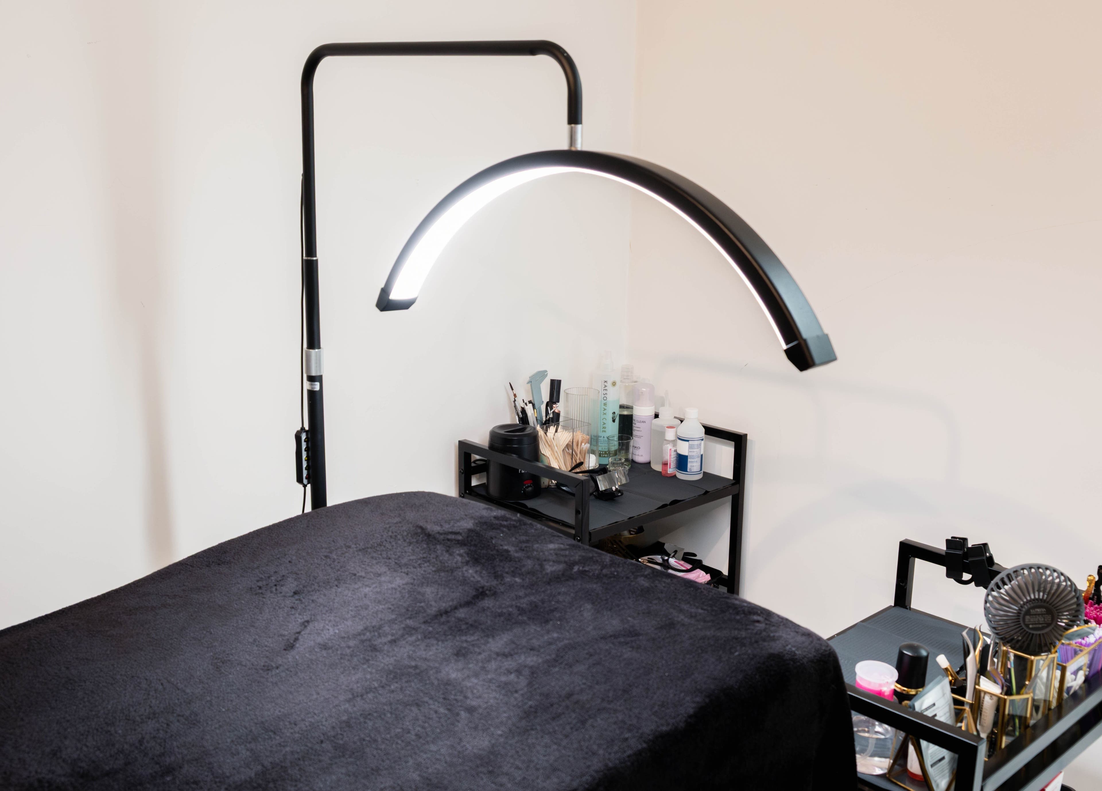 Cozy AV Lashes London room with black bed and beauty tools, located in London, England, GB.