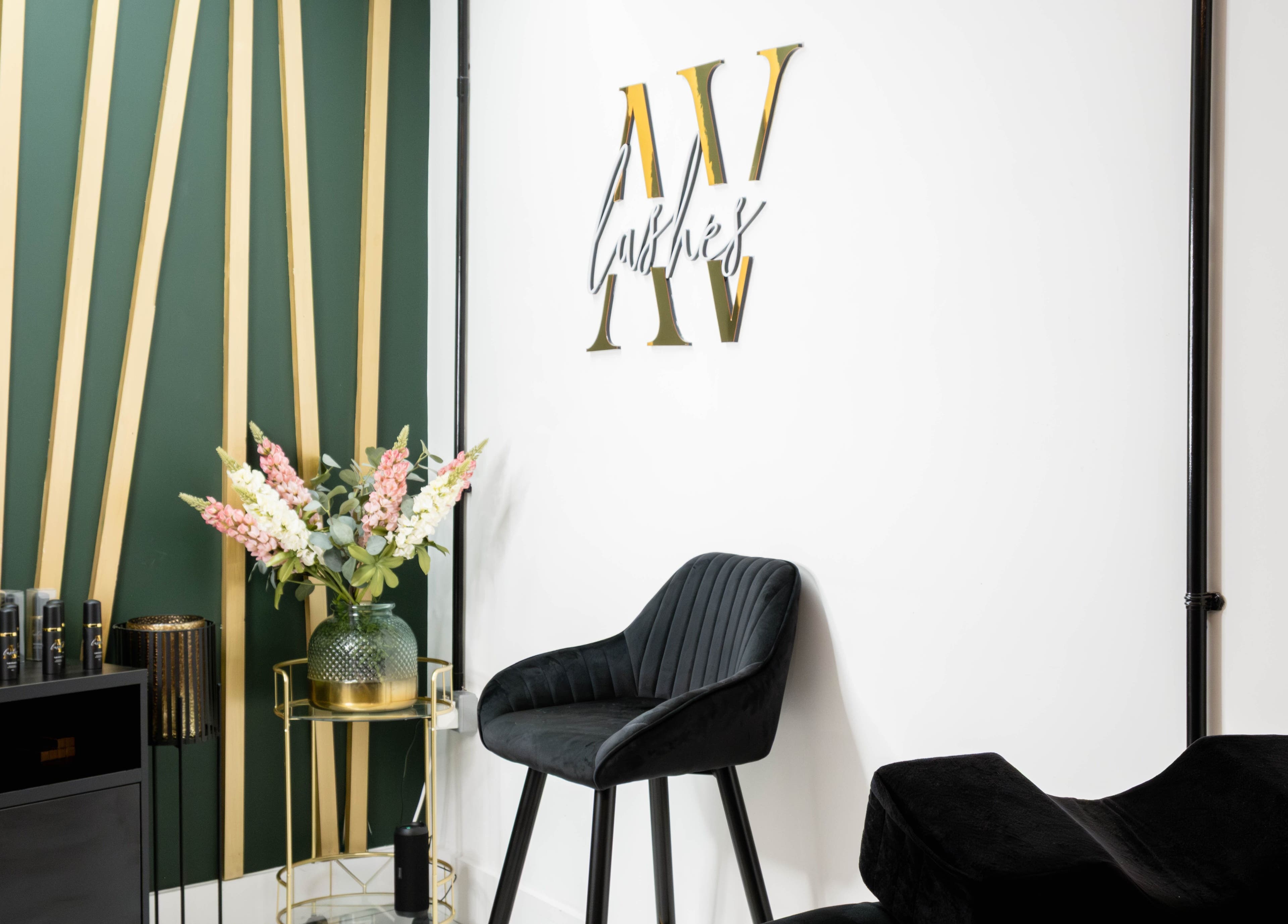 Elegant interior of AV Lashes London in London, England, GB with stylish decor and lush floral arrangements.