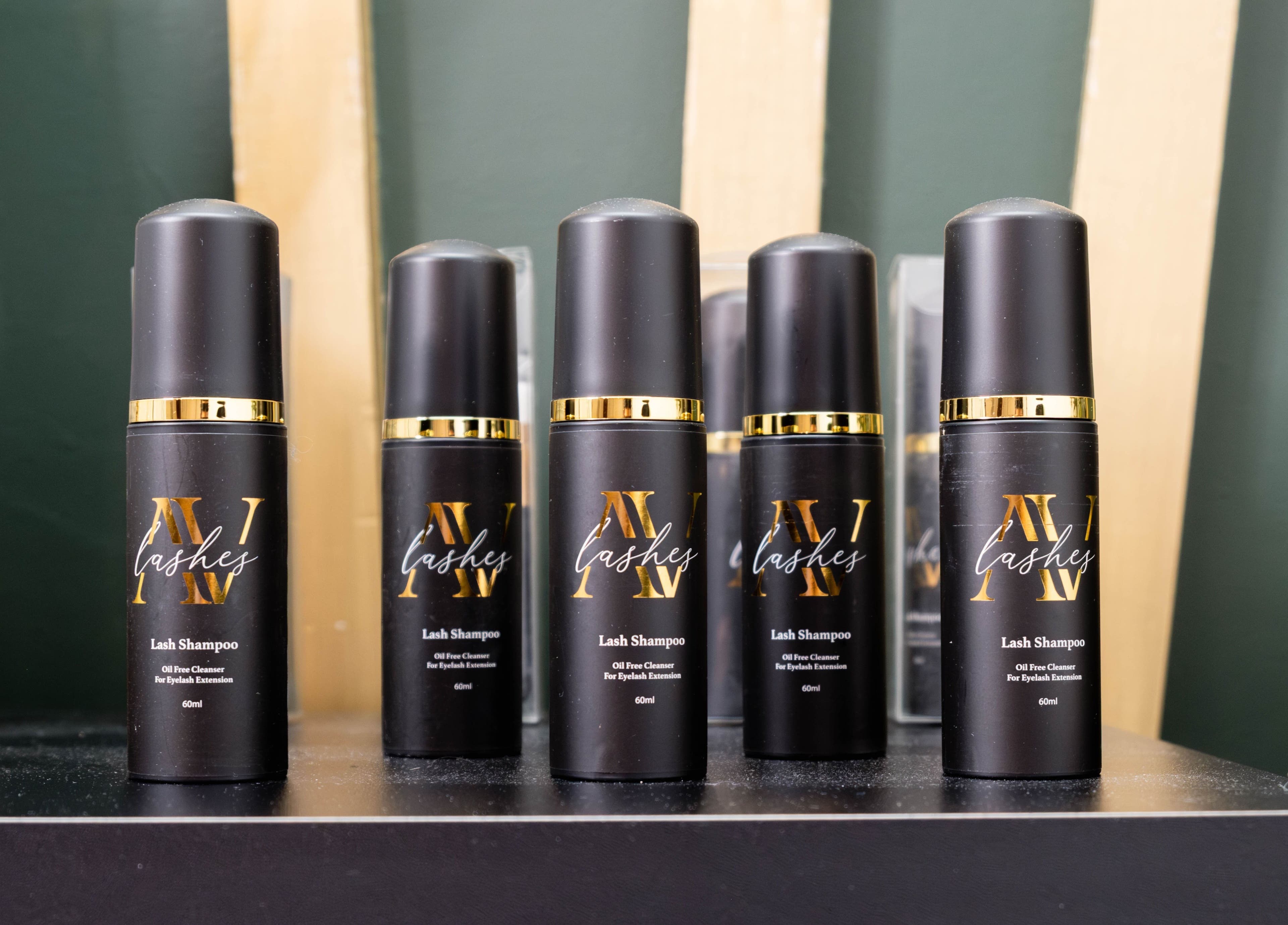 AV Lashes London eyelash shampoo bottles displayed on a shelf in London, England, GB beauty studio.
