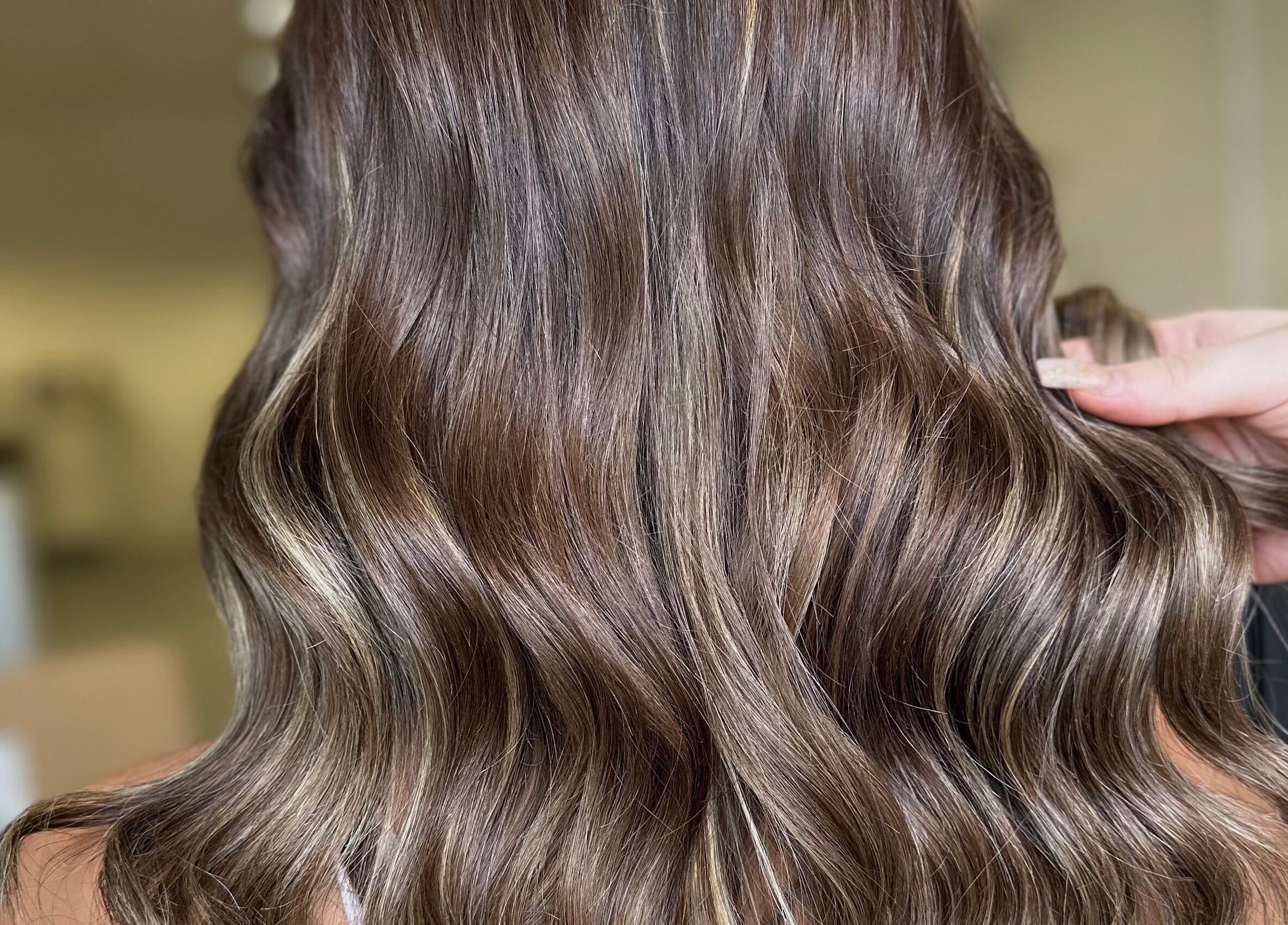 Glossy brown wavy hair styled at The Secret Salon, Dinnington, England, GB.