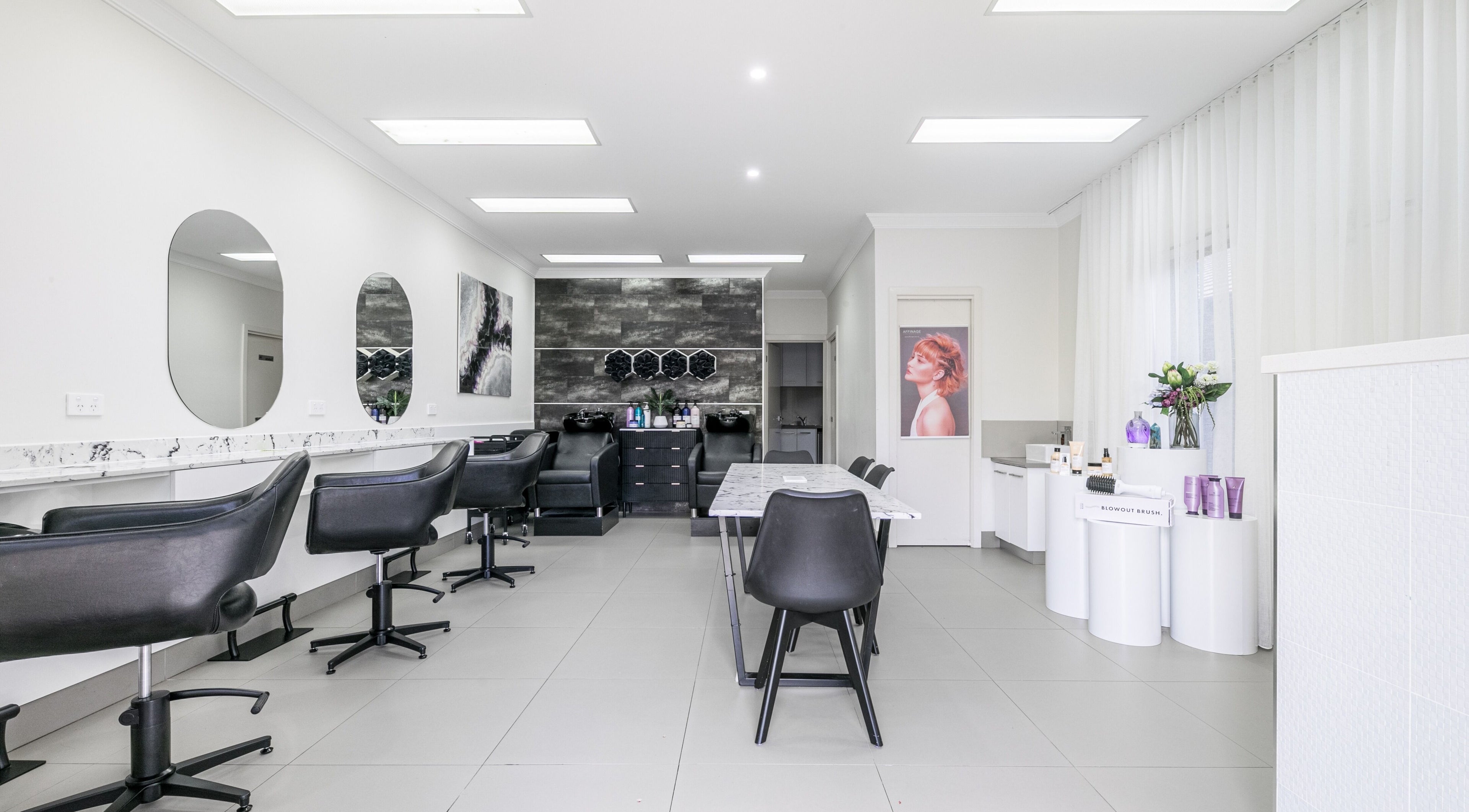 Modern salon interior at Priscilla's Hair and Beauty in Melbourne, Victoria, AU with sleek chairs and stylish decor.