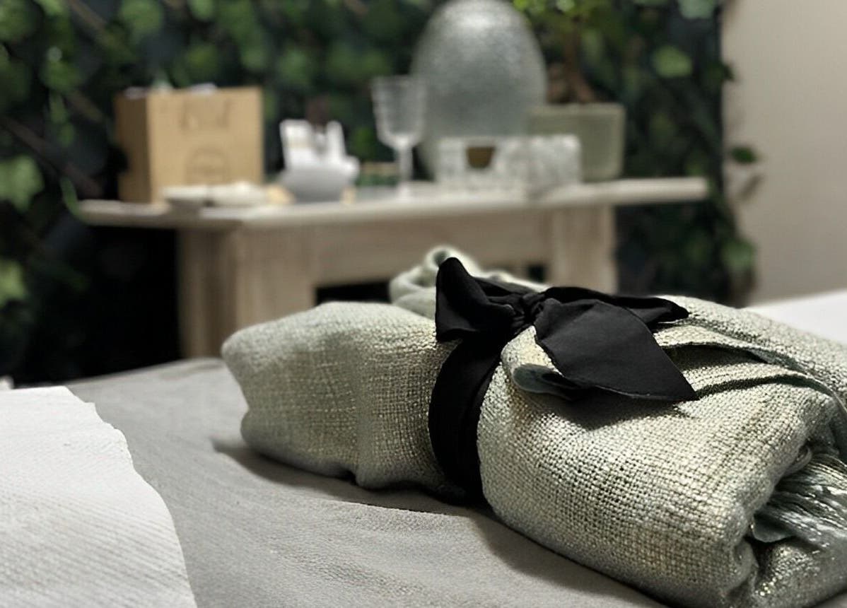 Relaxing spa setting at AfriU Refinery, George, Western Cape, ZA with lush greenery and delicate accents.