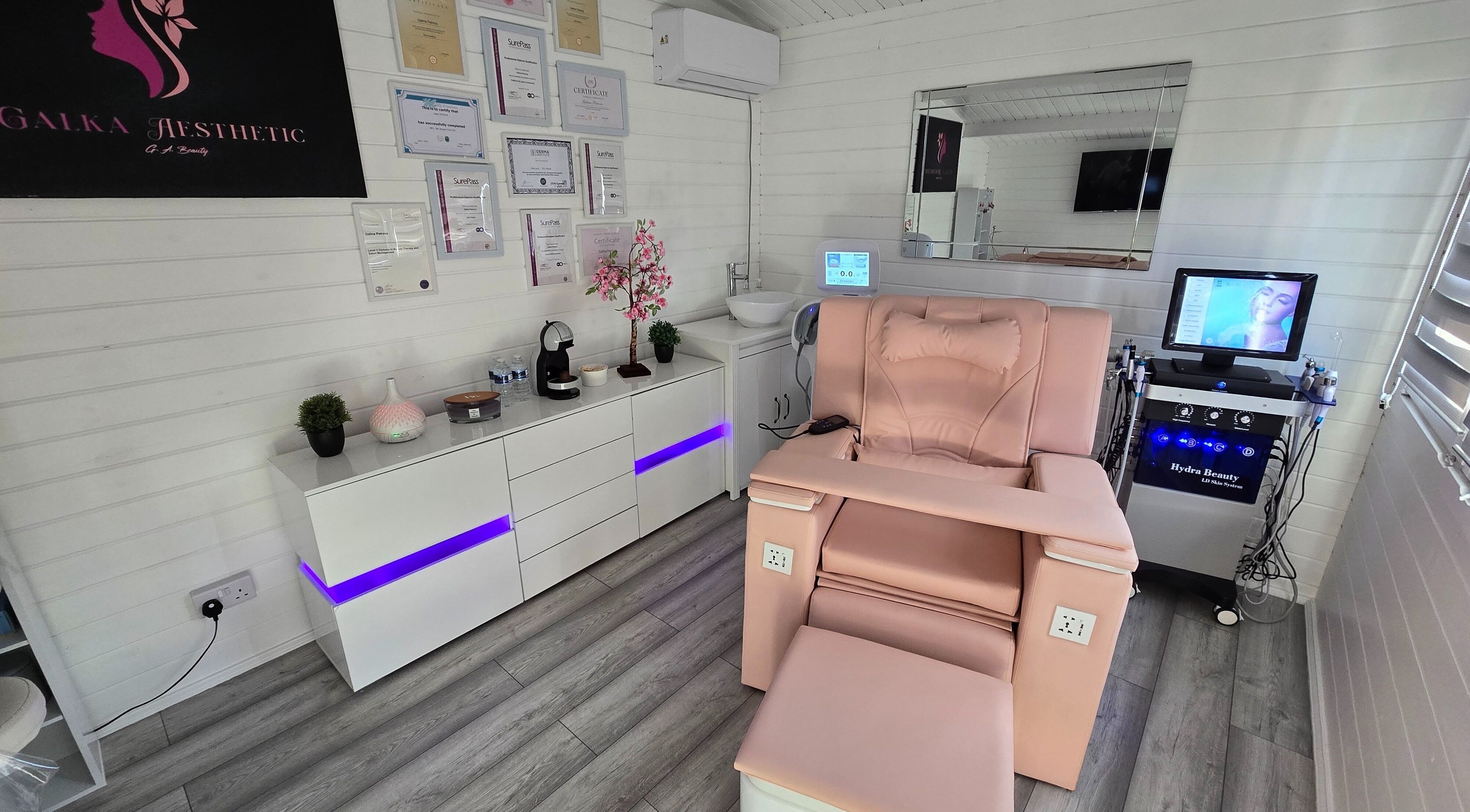 Relaxing treatment room at Galka Aesthetic in Norwich, England, GB featuring pink chair and modern decor.
