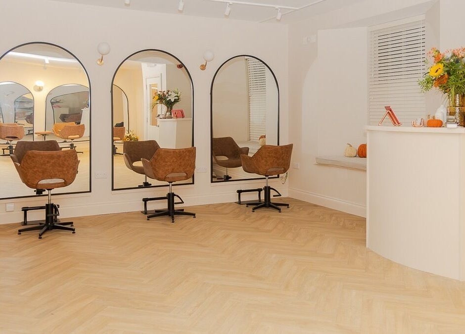 Chic, inviting interior of The Suite by Jennifer O’Kane in Limerick, IE with stylish salon chairs and mirrors.