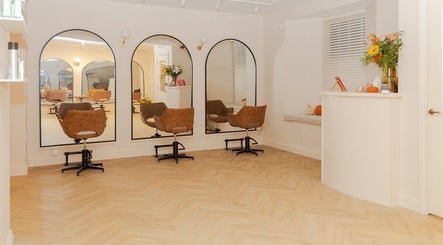 Chic, inviting interior of The Suite by Jennifer O’Kane in Limerick, IE with stylish salon chairs and mirrors.