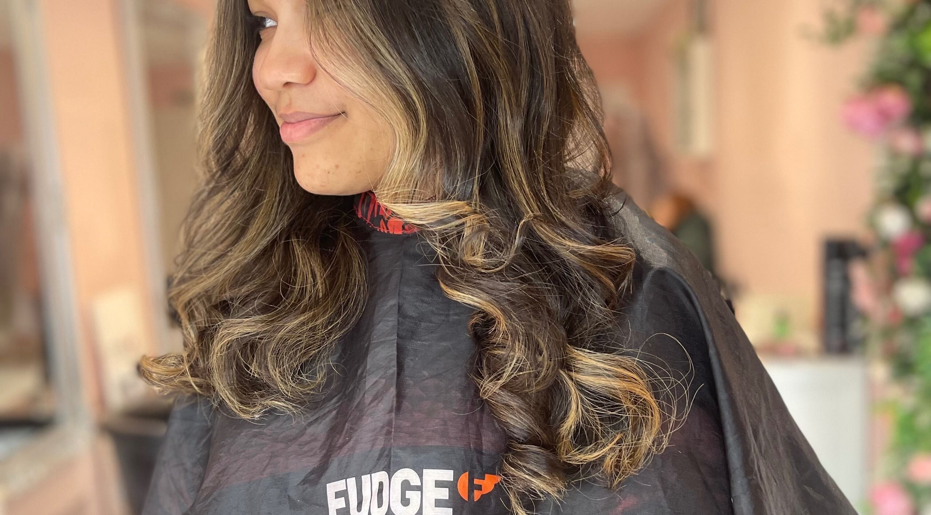 Woman with styled curls at Prinnylocks salon in Wythenshawe, England, GB.