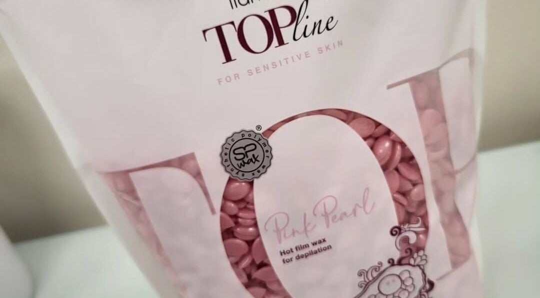 Bag of pink pearl hot wax at Bonnie & Bare Waxing, Dunfermline, Scotland, GB, ideal for sensitive skin treatments.