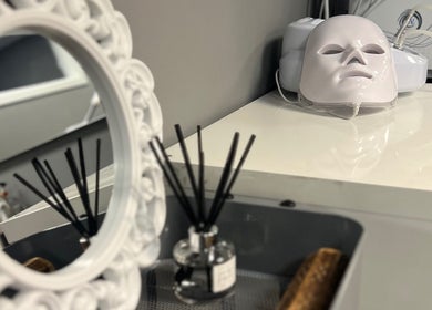 Elegant beauty setup at NKD Skin, Coatbridge, Scotland, GB with a decorative mirror and skincare device.